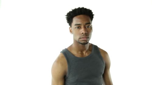 Black and fit Afro-american in his 20s man in studio a white background