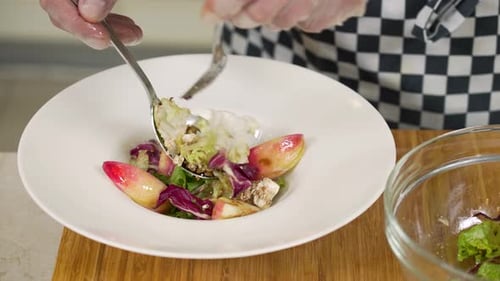Chef Prepares Salad with Peaches and Lettuce