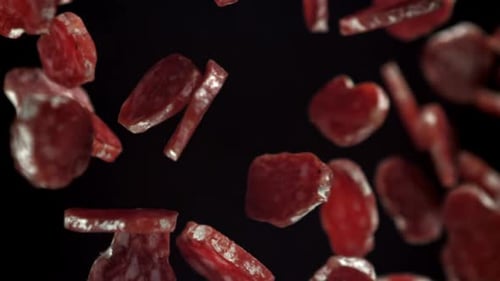 Slices of Pepperoni Floating in Slow Motion