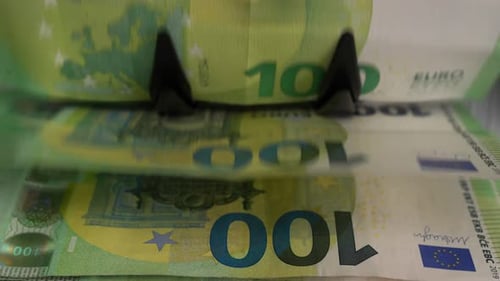 Machine Counting Green and Yellow 100 Euro Notes