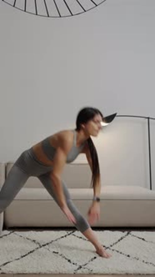 Athletic Woman Stretching on a Rug in Her Home