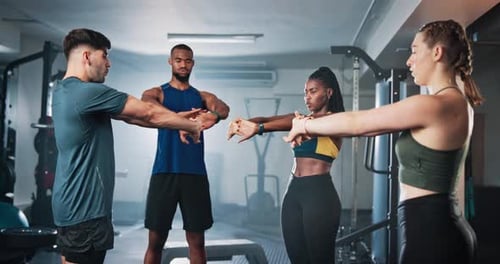 Fitness, personal trainer and people with stretching in gym for group training with arm workout