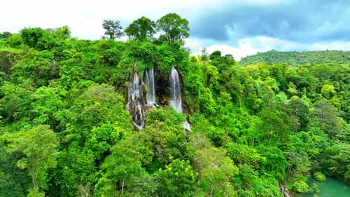 Beautiful waterfall in a tropical forest by aerial view from a drone.