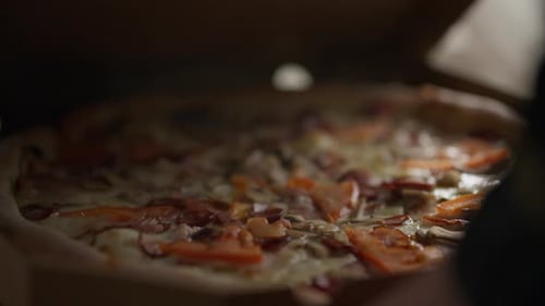 Hungry customer customer opens a cardboard box with pizza Customer received a fresh order Hot pizza