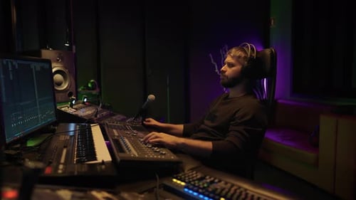 Soundman Working in Professional Record Studio Portrait of Man with Mixer Skilled Sound Director