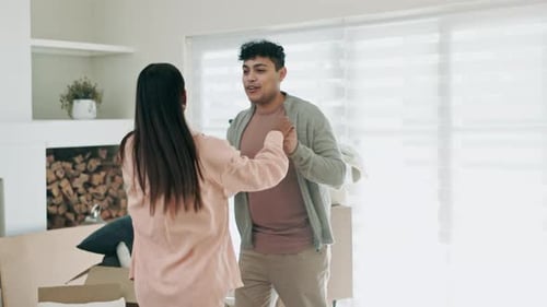 Couple, dancing and excited to celebrate new home or moving in together with real estate property