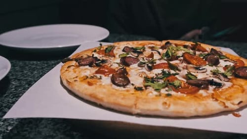 Fresh Pizza on the Table in the Restaurant