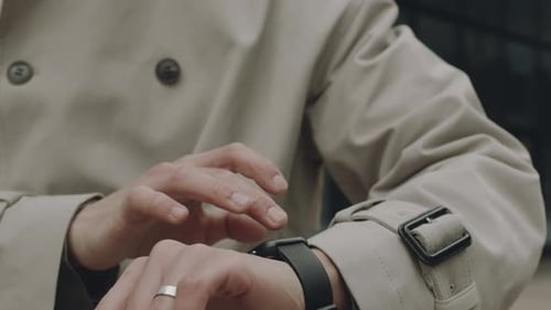 Man Using Smartwatch on Street