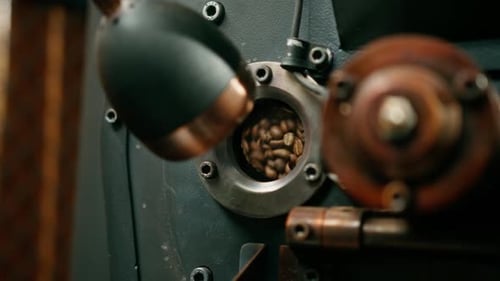 Coffee beans are rotated in a machine for roasting coffee beans close-up of craft coffee production