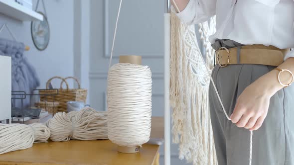 close-up stylish woman unwinds a rope from a reel, People Stock Footage ...