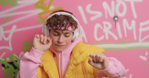 Teen Boy Dancing to Music with Headphones