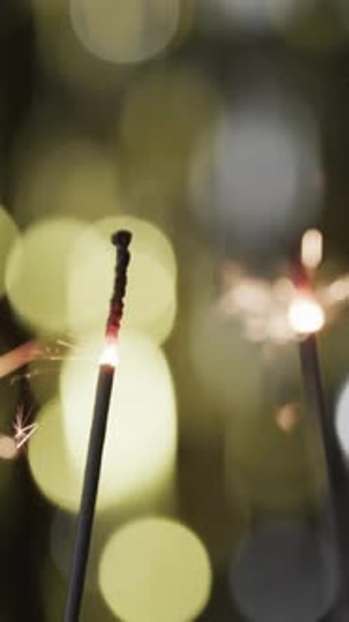 Festive Sparkler Emitting Radiant Golden Sparks at Night