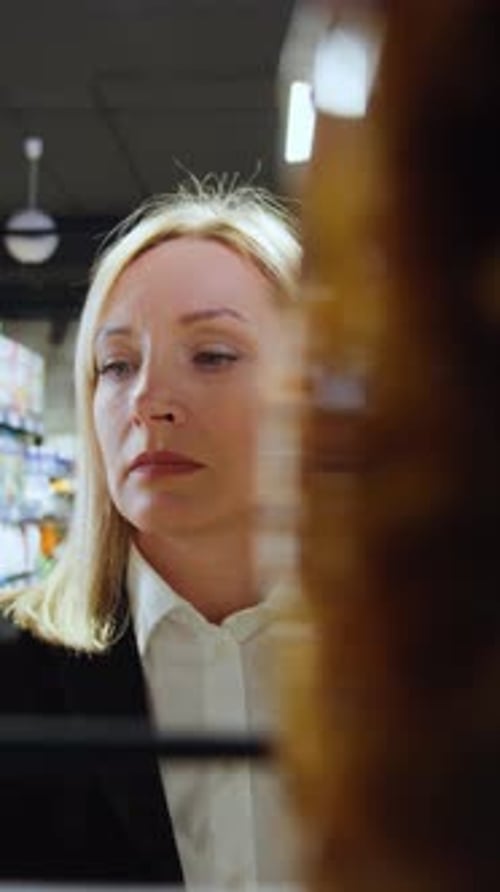 Woman Shopping for Pickles in Grocery Store