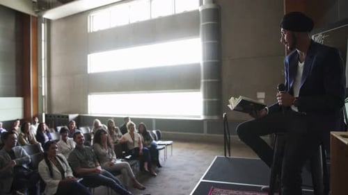 Speaker Presents to Audience in Modern Room