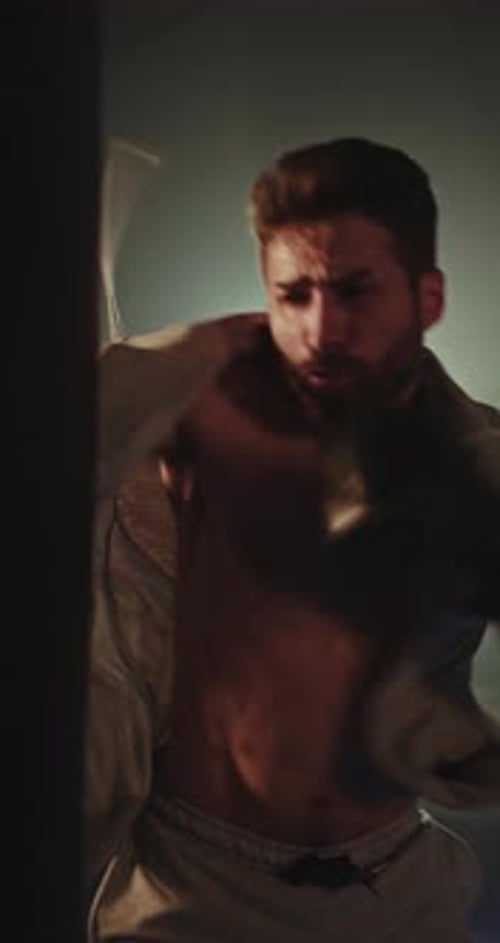 Muscular Man Boxing in an Indoor Gym