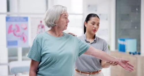 Senior Woman Exercising Arm with Therapist Help