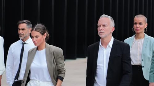 Confident Adults in Business Attire Walking Forward