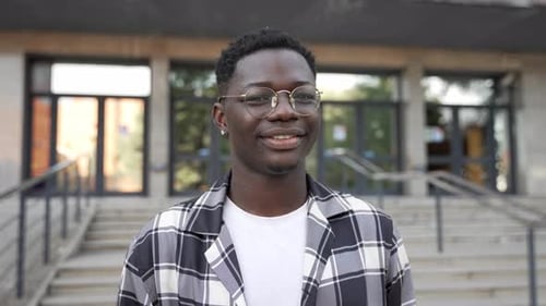 Portrait of Young Joyful African Man with Eyeglasses Smiling Looking at Camera University Student