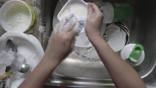 Close-up on Female Hands Washing Dishes in Kitchen, View From Top, Overhead View