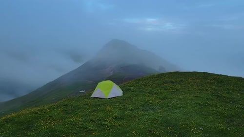 a Tent is Sitting on Top of a Grassy Hill