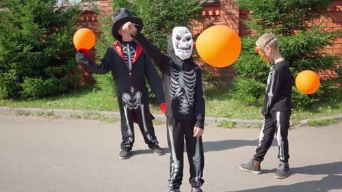 Halloween Prepare to Collect Candy Boy in Skeleton Costume Dances on Street Trick or Treating