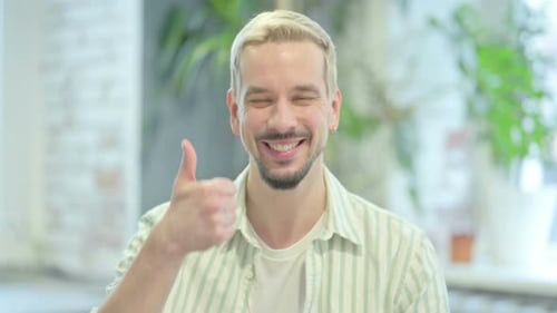 Man Giving Thumbs Up, Smiling at Camera