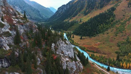 Aerial view of river surrounded with green trees and mountains