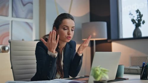 Businesswoman Video Conferencing on Laptop in Modern Office
