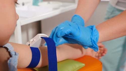 Child Receives Medical Exam Preparation at Clinic