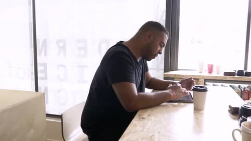 Businessman Drinking Coffee Using Digital Tablet at Cafe 3539 Years
