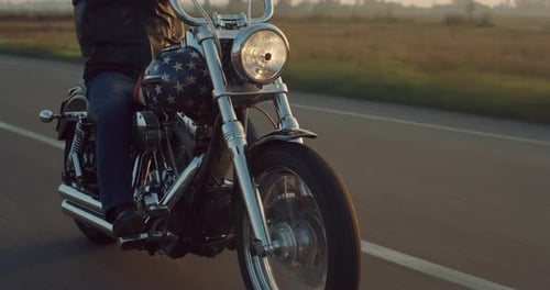Close Up on a Vintage Custom Motorbike with American Flag Paint Driving on a Countryside High