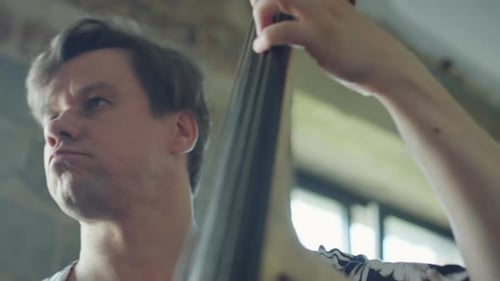 Man Playing Upright Bass in Close Up Shot