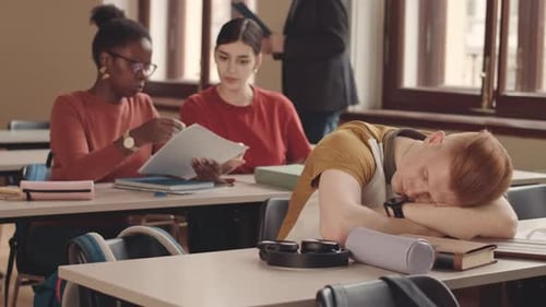 Students in Class, One Asleep at Desk