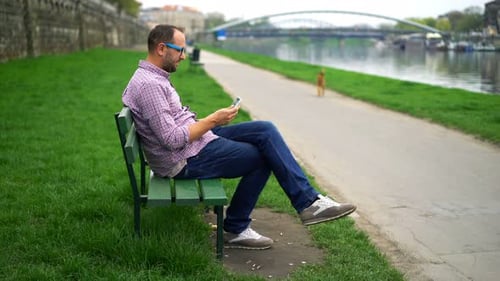 Young Man Using Tablet Computer Standing on Terrace in City 30s
