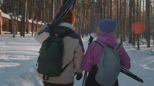 Elderly Couple Chatting on Way to Skiing Track in Winter Forest