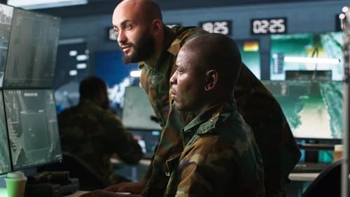 Men in Uniforms Work on Computers