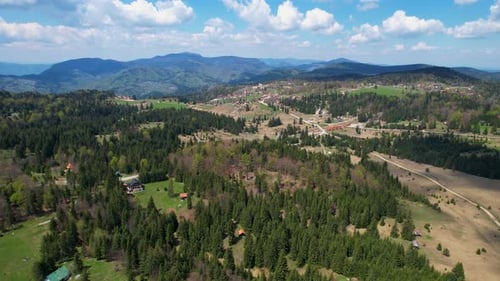 Mountain Village Landscape with Forests, Fields, and Distant Hills