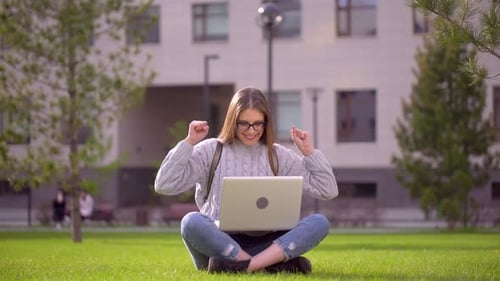 Woman Student with Laptop Outdoors Smiling Exams Admission to University Celebration Education