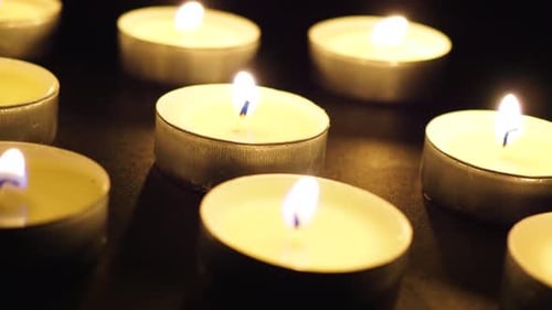 Candles in the dark rotating dolly slide macro close-up