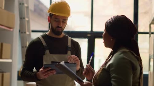 Coworkers Check Warehouse Inventory