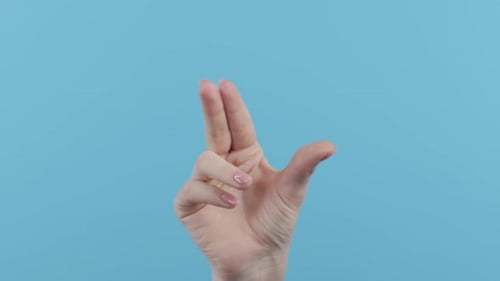 Female Finger Pinch Zooming Using Touchscreen Transparent Screen on Blue Studio Background
