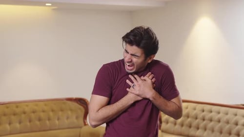 Young Indian man having a heart attack