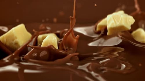 Chocolate Super Slow Motion White Chocolate Falls Into Milk Liquid Filmed on a Highspeed Camera at