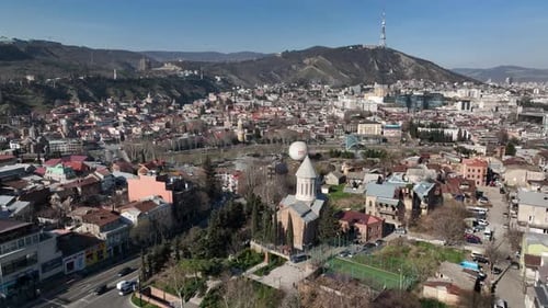 Aerial view of Tbilisi city central park and Bridge of Peace. Beautiful cityscape of Tbilisi