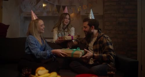 Friends Celebrating Birthday Together Indoors with Gifts