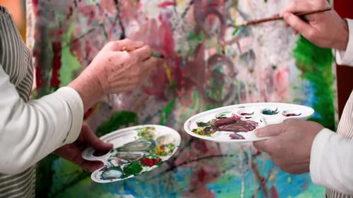 Adults Painting Abstract Art on a Canvas