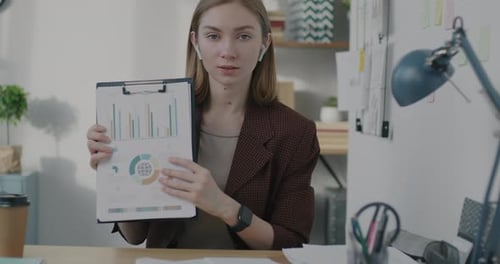 Slow Motion Portrait of Office Worker Speaking and Showing Business Document During Online Video