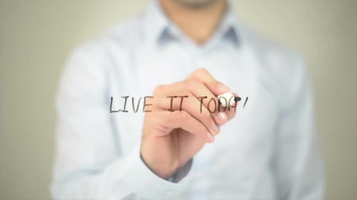 Man Writes "Live It Today" on Transparent Surface