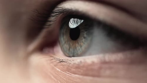 Young Caucasian Woman with Blue Eyes Looking Away in Macro Closeup of Studio
