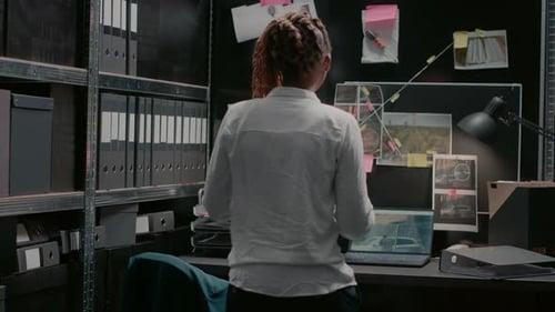 Female Detective Reviewing Evidence in her Office
